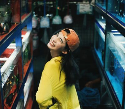 photo-of-smiling-woman-in-yellow-top-and-orange-hat-posing-3208616